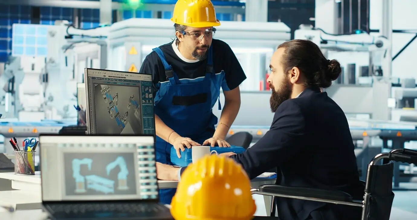 Engineer in a wheelchair at a photovoltaics factory enhancing the efficiency of solar panels
