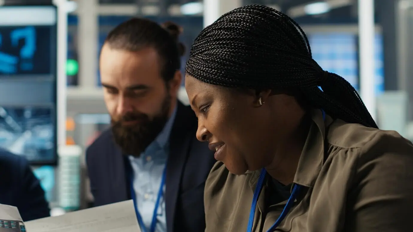 A factory manager is using a tablet to integrate automation technology.